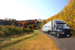 Moving truck driving in the fall