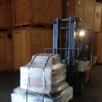forklift driver moving recycled electronics