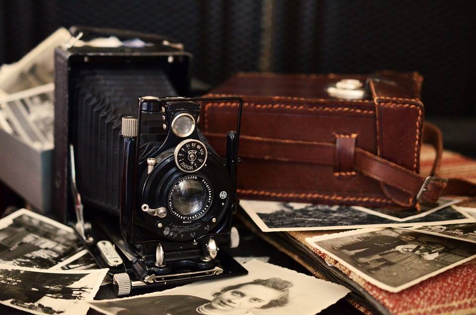 antique camera and photos on table