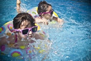 Two Girls Swimming in a Pool”] 