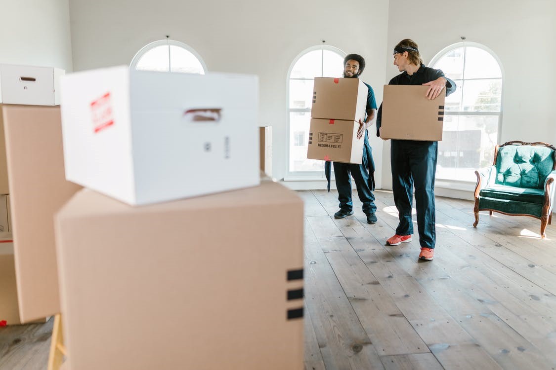 two men holding boxes